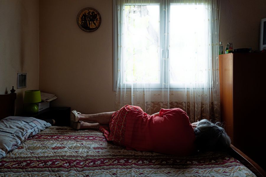 My mother Sofia, who suffers with dementia, takes an afternoon nap at her home in Kalamos, Greece