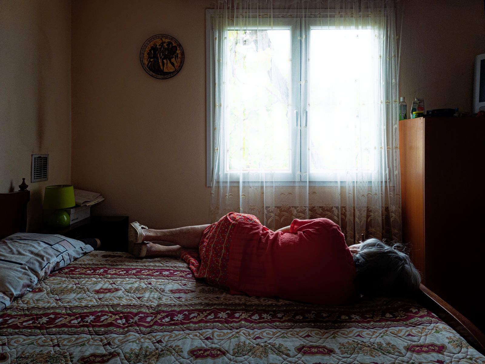 My mother Sofia, who suffers with dementia, takes an afternoon nap at her home in Kalamos, Greece