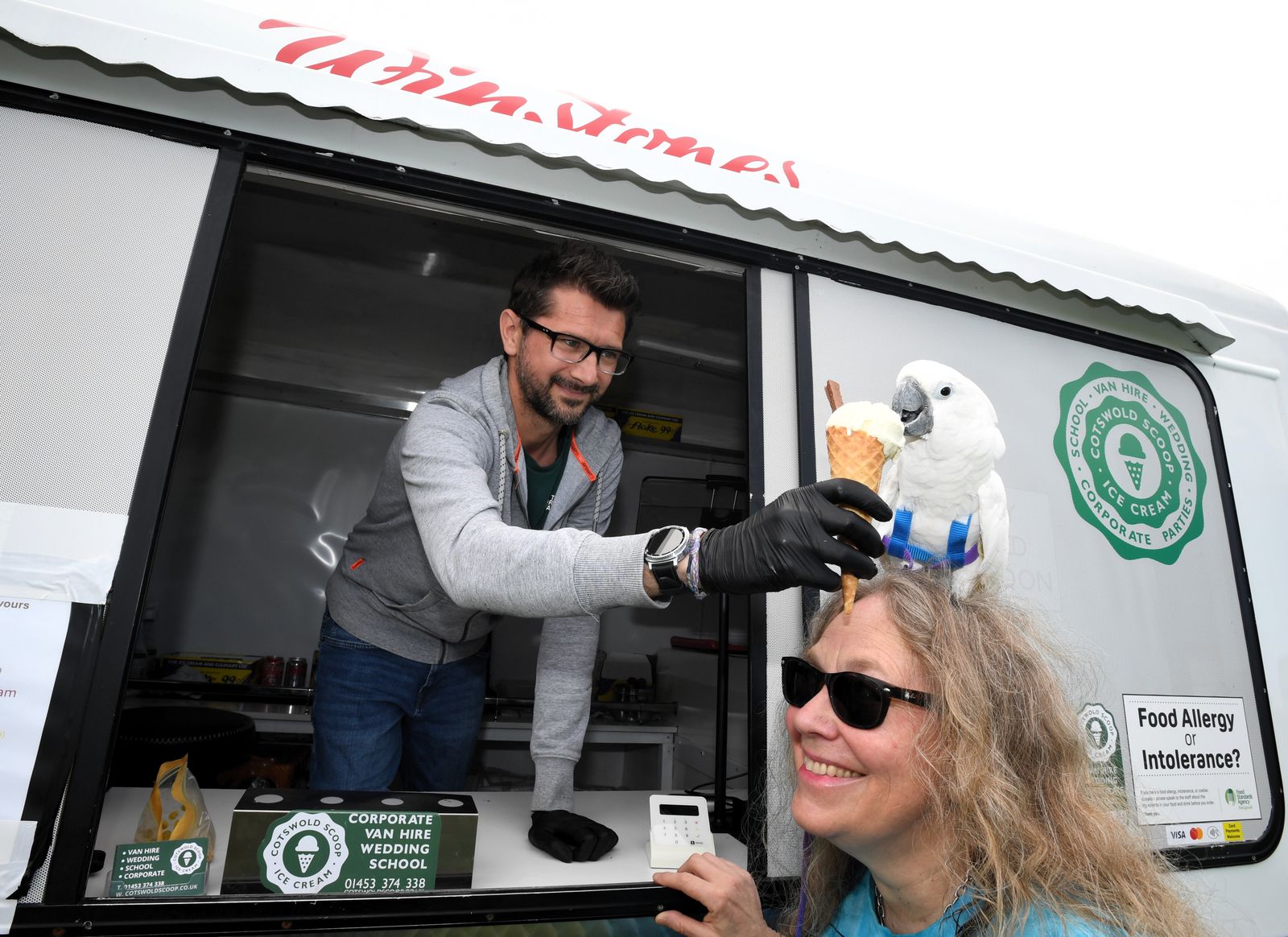Cockatoo eating Ice Cream at an Ice Cream van during heatwave Stroud Gloucestershire Paul Nicholls